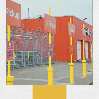Faux-Polaroid of a retail pickup area with yellow bollards, orange signs reading "Pickup", and a bright orange building.